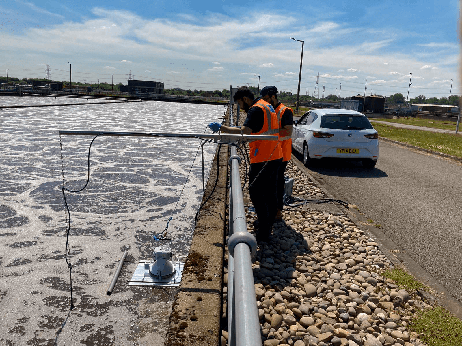 LI-7820 floating in water taking measurements with researchers observing